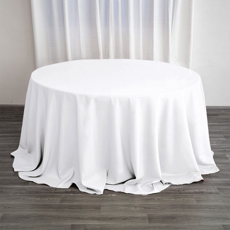 a round table with white cloth on it