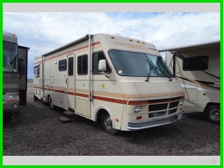 two recreational vehicles parked next to each other