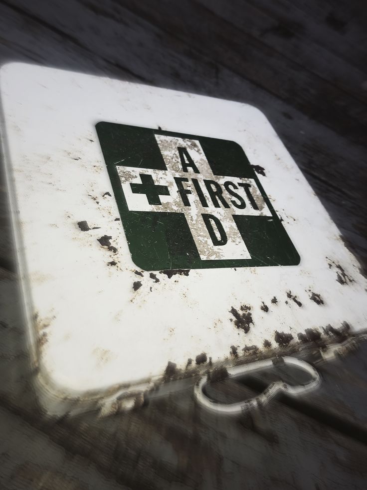 a white and green sign sitting on top of a wooden floor