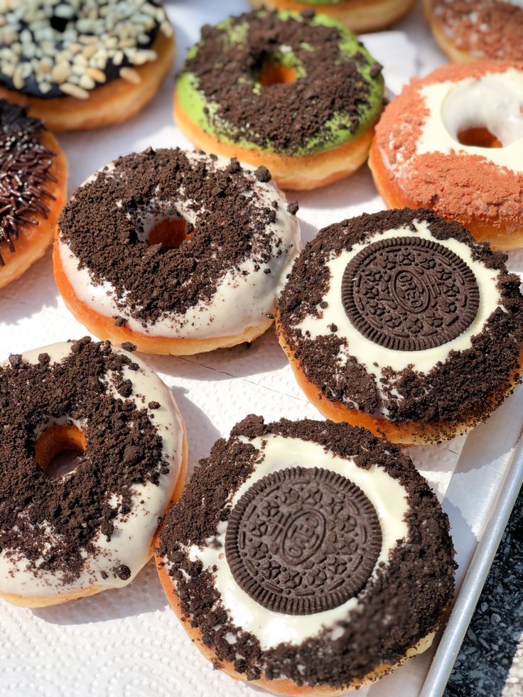 an assortment of doughnuts with oreo cookies on them