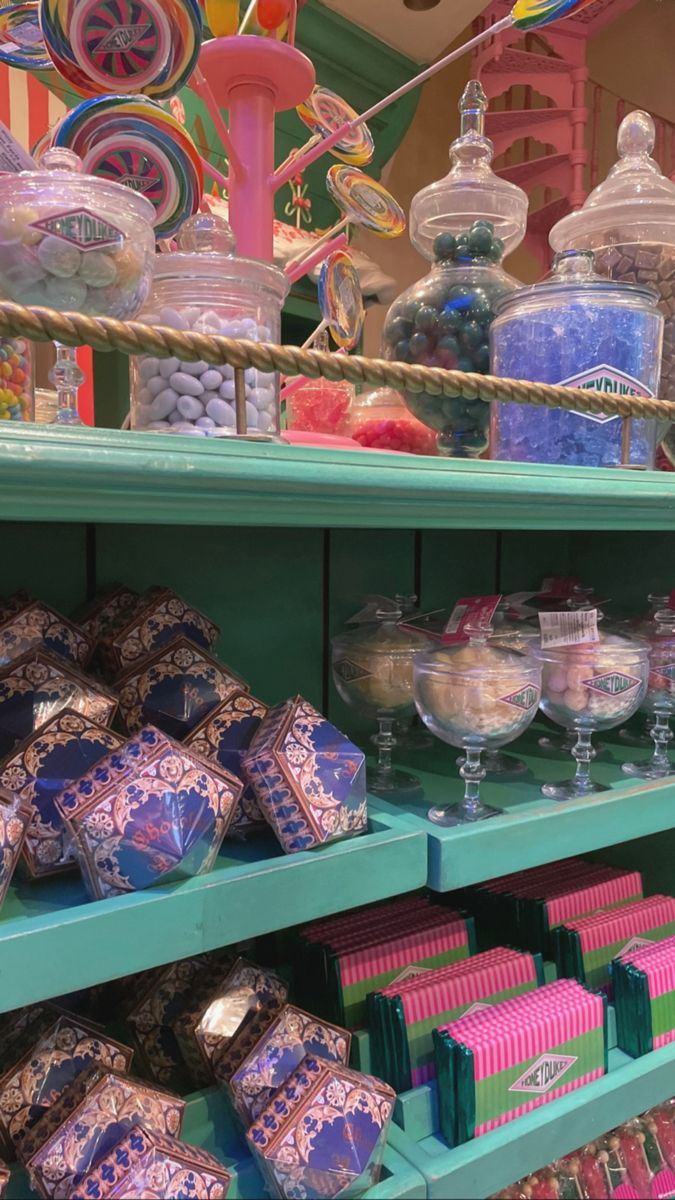 the shelves are filled with many different types of candies and candy bars in glass containers