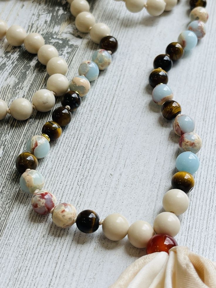 https://s3.commentsold.com/rush/products/Pn1TgtiCcGYH8FnDqeVkNWqN7VEvME4VLy5c3USG.jpg Adjustable Long Gemstone Beads Necklace, Adjustable Hand-strung Necklaces For Layering, Adjustable Necklace For Layering, White Gemstone Beads Lariat Necklace, White Lariat Necklace With Gemstone Beads, Hand Knotted White Round Bead Jewelry, Spiritual Lariat Necklace With Round Beads, White Hand Knotted Jewelry With Round Beads, White Spiritual Necklaces For Layering