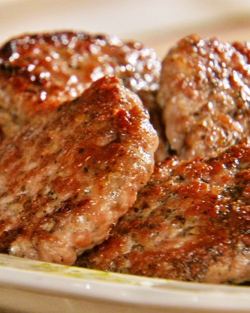 some meat patties are sitting on a plate