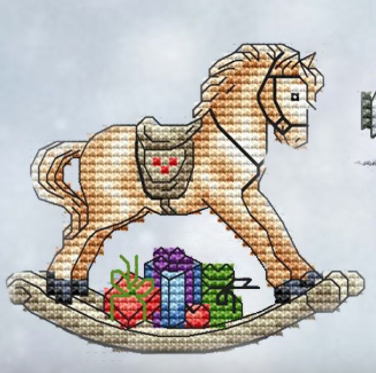 a cross stitch horse with presents on it's back