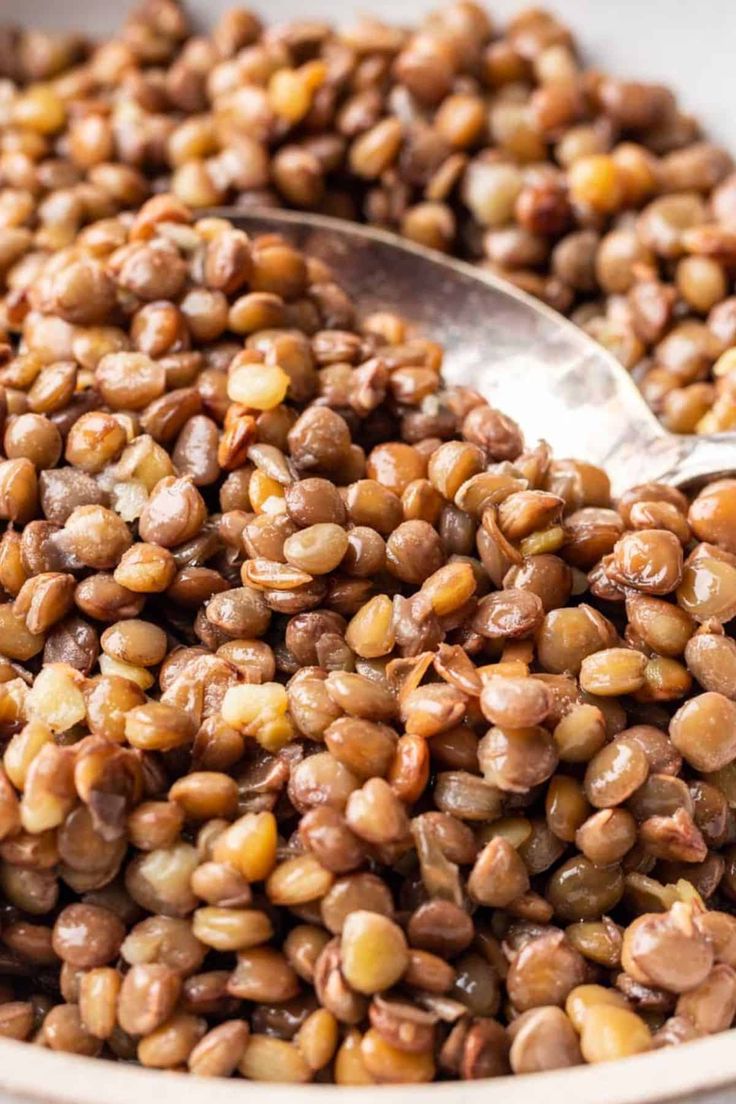 a bowl filled with lentils and a spoon