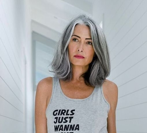 a woman with grey hair wearing a tank top