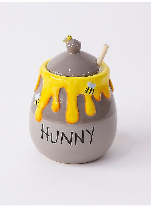 a grey and yellow ceramic pot with the word hummy painted on it