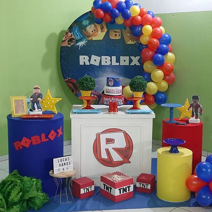 a room with balloons, toys and decorations on the floor in front of a sign that reads robblox