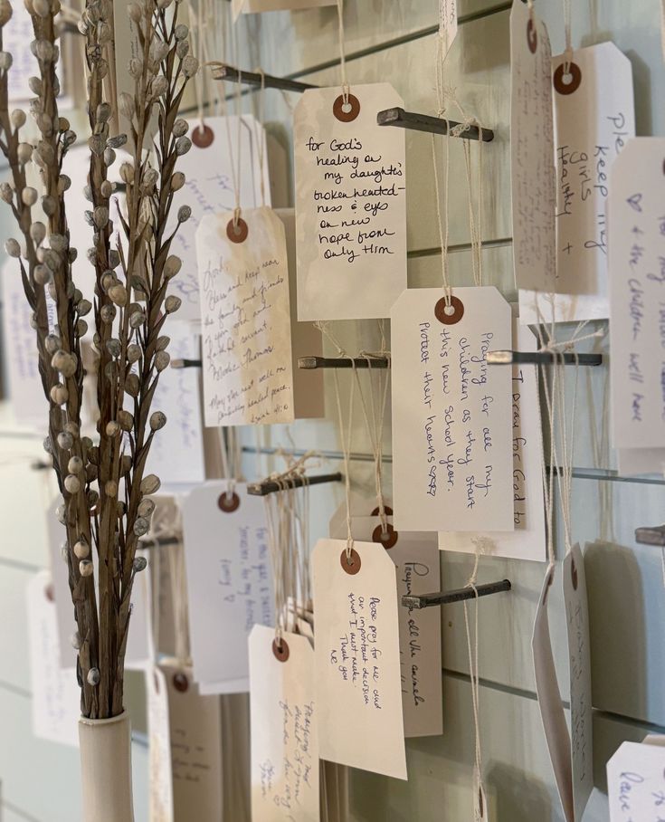 there are many cards attached to the wall with flowers in vases next to each other