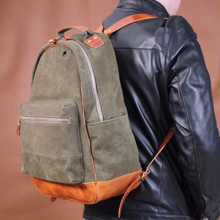 This is a backpack made of military fabric (waxed canvas) and full-grain crazy horse cowhide, also known as a paratrooper backpack. It is a multi-functional backpack with the characteristics of WATERPROOF,OIL-PROOF,AND TEAR-RESISTANT. It is suitable for outdoor activities, walking, cross-country, exploration and travel. It is very thick, wear-resistant and durable. The pockets on both sides of it can hold umbrellas, water cups, a bottle of beer or red wine. There is a headphone jack on it, which Green Waxed Canvas Backpack, Hermes Canvas Backpack, Military Style Durable Outdoor Bags, Waxed Canvas Backpack, Military Style Bags With Pockets For Hiking, Military Backpack, Military Style Outdoor Bag With Adjustable Strap, Adventure Gear, Wired Headphones