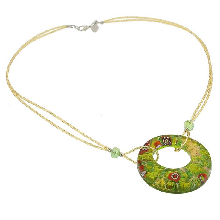 Enjoy the play of light and colors and make a statement of Italian elegance and Venetian splendor with this hand-made Murano Glass necklace. Richly colored and artistically crafted Murano pendant infused with 24K gold foil and a sprinkle of Millefiori pieces is elegantly suspended from exquisite seed bead necklace accented with Swarovski crystals. Express your love of Venice with this Murano Glass beauty, or make it a unique and memorable gift. The combination of famous Italian design with quali Artistic Glass Necklace With Round Pendant, Artistic Glass Round Pendant Necklaces, Artistic Glass Round Pendant Necklace, Artistic Round Glass Necklaces, Artistic Green Glass Jewelry, Elegant Necklace With Artistic Round Pendant, Elegant Green Glass Necklaces, Murano Glass Round Necklace For Gifts, Murano Glass Round Necklaces For Gifts