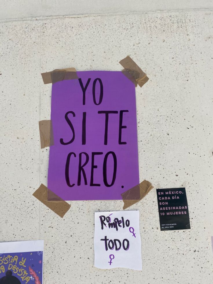 a purple sign that says yo site creo on it and some stickers attached to the wall