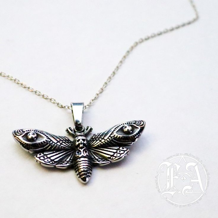 Indulge in the captivating beauty of our stunning Cicada design Necklace. Made of high-quality alloy with a unique pendant measuring 1.5 x 1.0 inches, it comes with a delicate 20 inch chain for a sophisticated touch. Elevate your dark fashion game with this exquisite piece! Spiritual Metal Chain Necklace For Gift, Silver Alloy Necklace For Gift, Symbolic Silver Alloy Jewelry, Handmade Silver Alloy Charm Necklaces, Silver Brass Jewelry With Lobster Clasp, Sterling Silver Pendant Chain Necklace, Handmade Silver Charm Necklace In Alloy, Silver Metal Chain Necklace As Gift, Silver Metal Chain Necklace For Gift