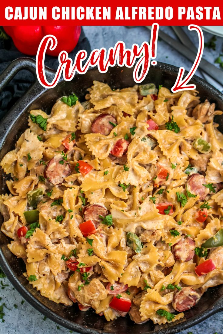 a skillet filled with chicken alfredo pasta and topped with parsley on the side