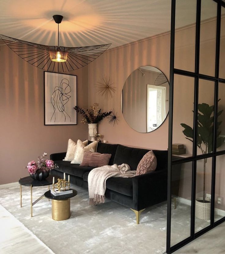 a living room filled with furniture and a large mirror on the wall above it's headboard