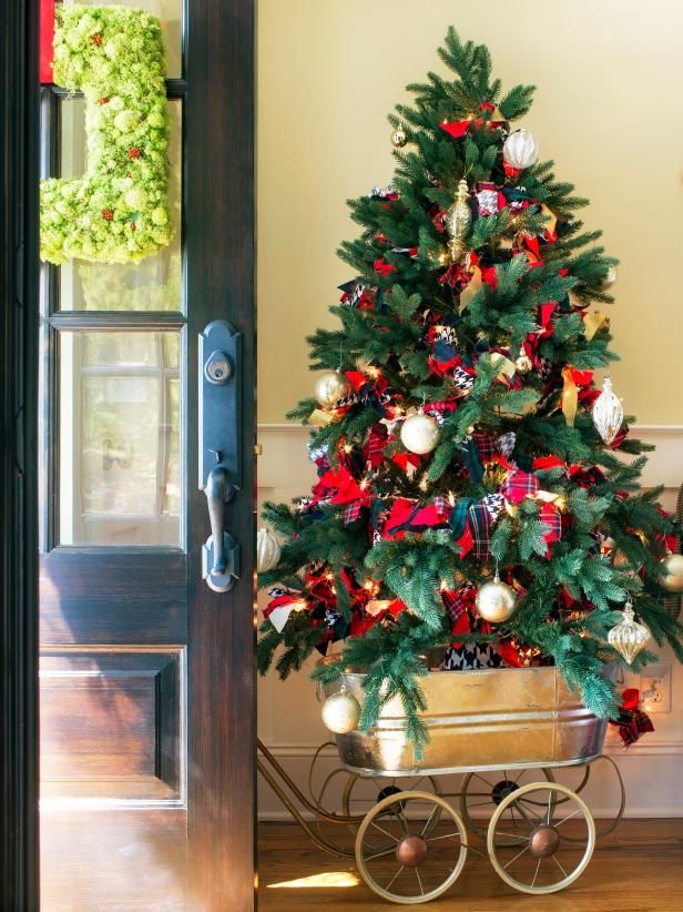 a decorated christmas tree in front of a door