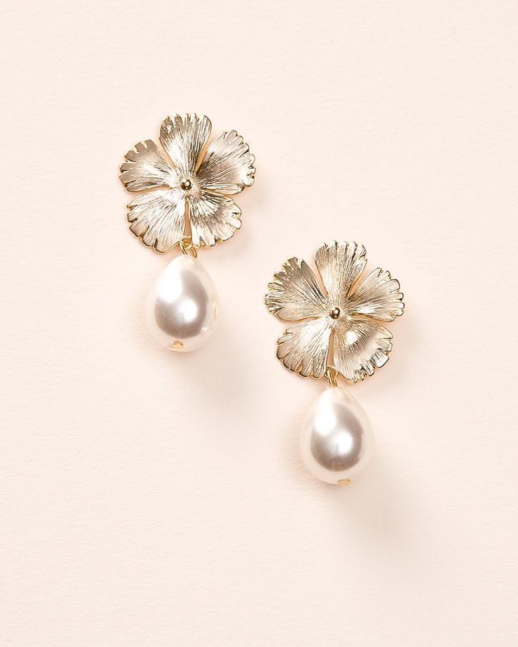 Bring a soft, feminine touch to your wedding day look with our Hayden Pearl Earrings. Each detailed metal flower is accented with an off white pearl drop that dangles effortlessly. Off white pearls Measures 1" x 1.5" long Hypoallergenic, lead-free & nickel-free Style #4456 Metal Jewelry With Flower Charm For Wedding, Wedding Jewelry With Metal Flower Charm, Feminine Metal Jewelry For Wedding, Pearl Drop Flower-shaped Bridal Earrings, Classic Flower Shaped Earrings For Wedding, Delicate Pearl Drop Earrings With Flower Shape, Delicate Pearl Drop Earrings In Flower Shape, Formal Dangle Flower Earrings With Pearl Drop, Formal Pearl Drop Dangle Flower Earrings