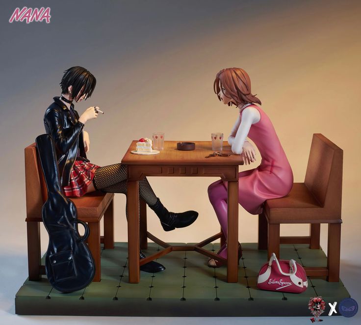 two figurines are sitting at a table and one is looking at the other