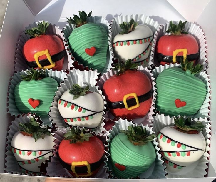 a box full of chocolate covered strawberries with decorations