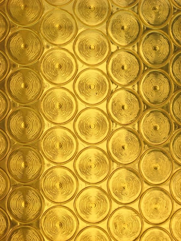 an abstract gold background with circles and dots