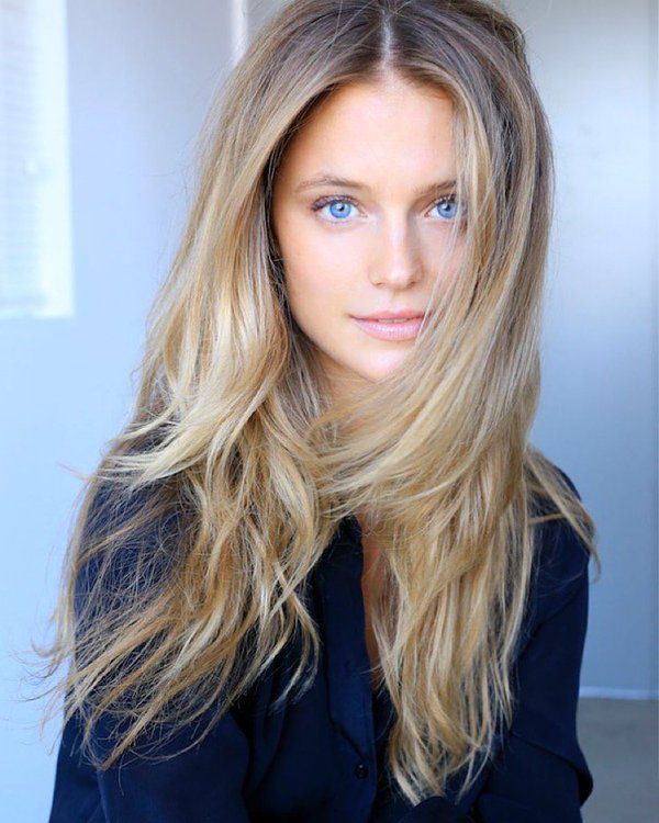 a woman with long blonde hair and blue eyes