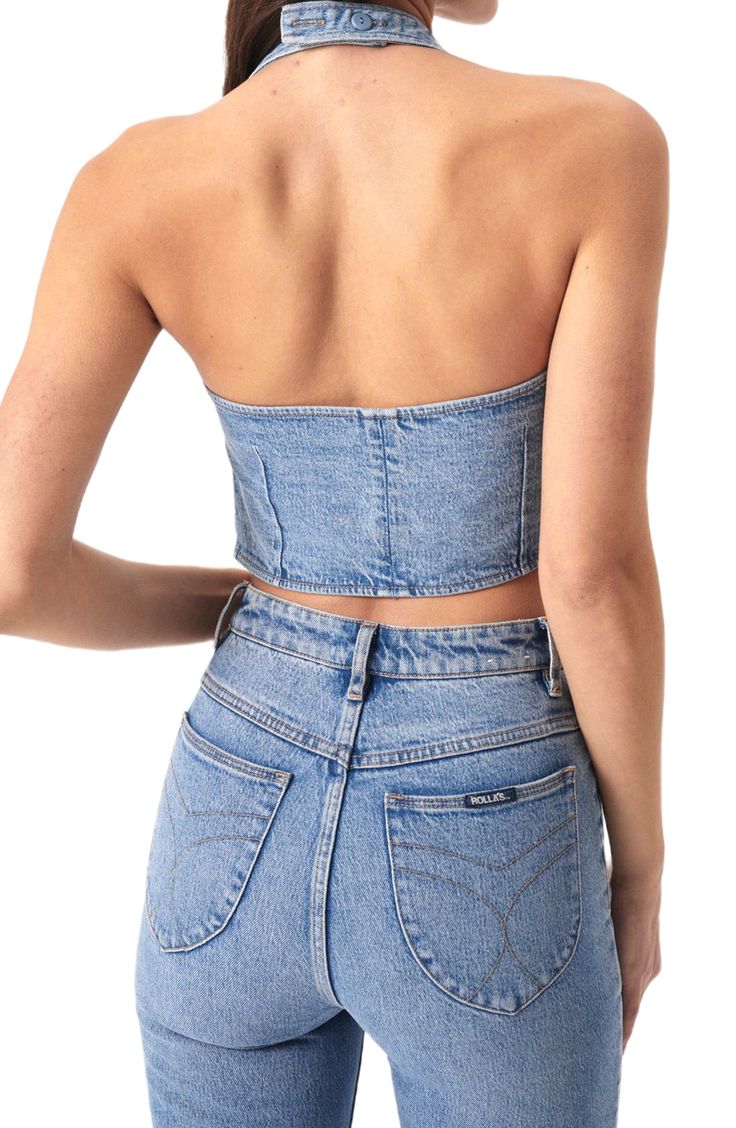 This faded denim top is crafted in a cropped silhouette and designed with a sleek halter neck. 18 1/2" center front length; 16 1/2" center back length (size Medium) Halter neck 99% organic cotton, 1% elastane Machine wash, line dry Imported Fitted Sleeveless Crop Top In Medium Wash, Fitted Dark Wash Sleeveless Crop Top, Stretch Denim Blue Crop Top For Summer, Fitted Sleeveless Dark Wash Crop Top, Fitted Denim Sleeveless Crop Top, Denim Blue Strapless Crop Top For Spring, Spring Stretch Denim Tube Top, Fitted Denim Halter Neck Top, Strapless Denim Blue Crop Top For Spring