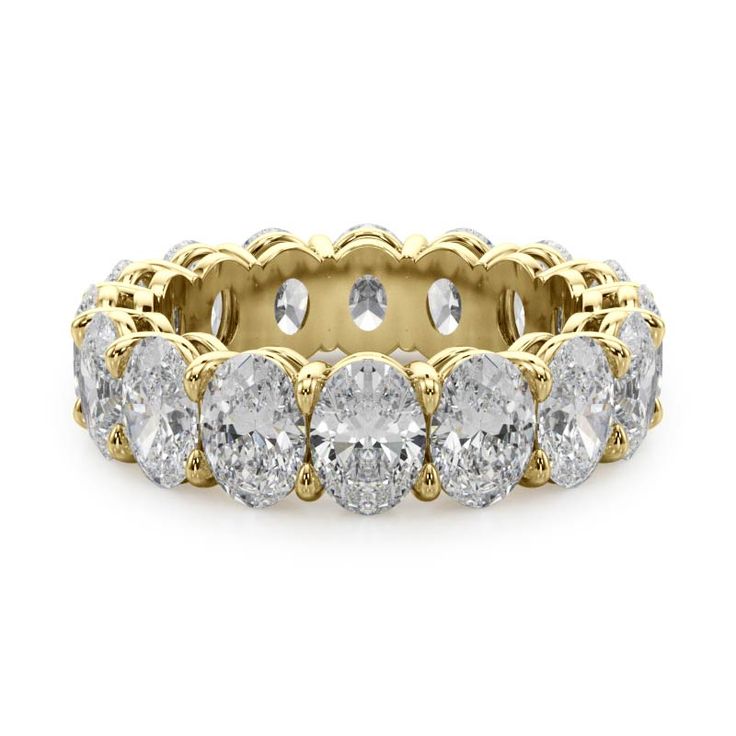 a yellow gold ring with five round cut diamonds on the side and two rows of smaller stones