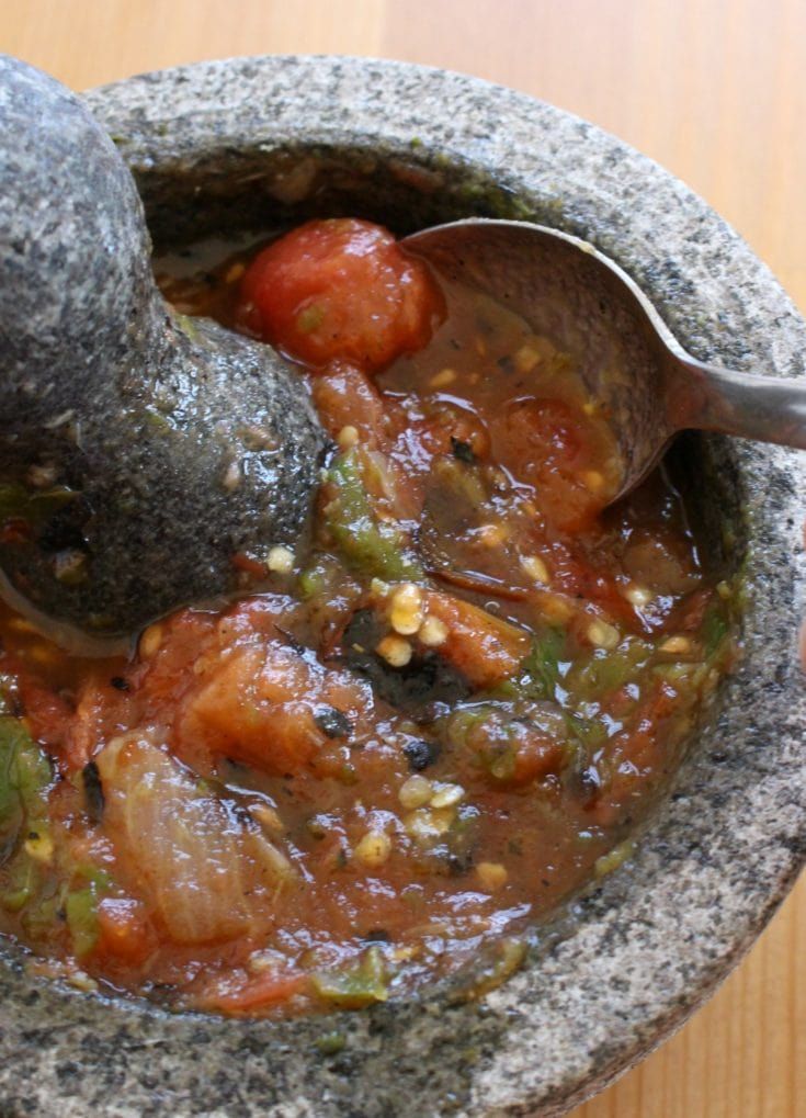 a spoon in a bowl filled with food