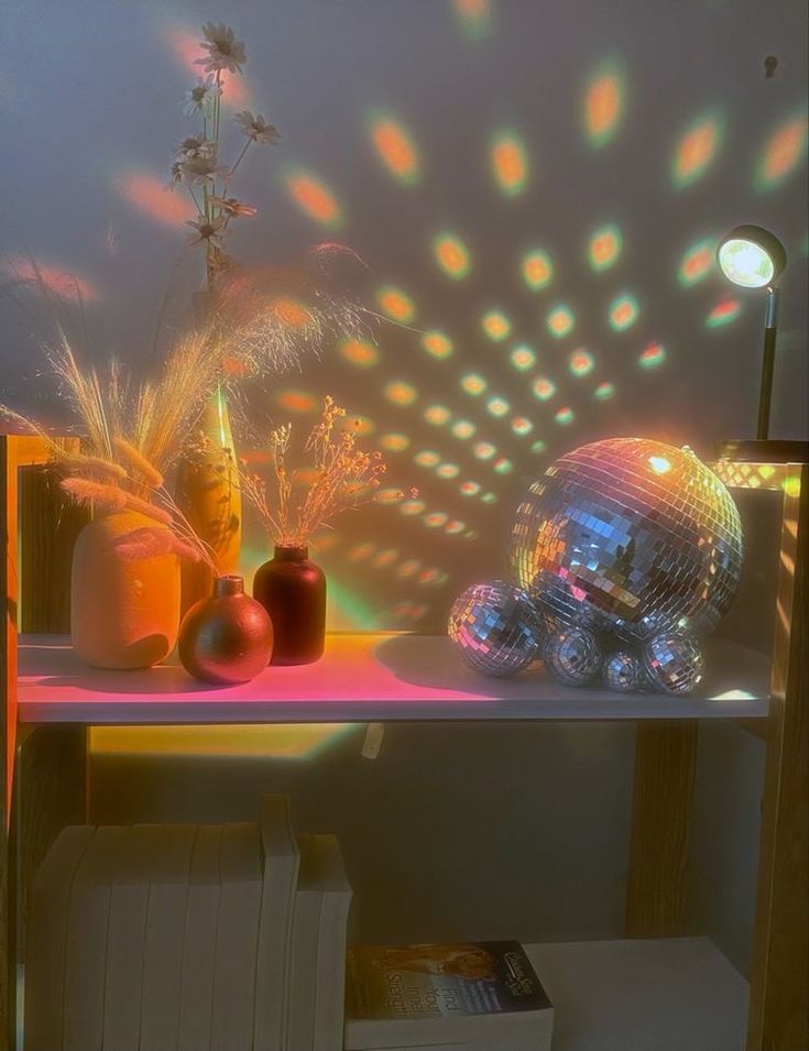 a table topped with vases filled with flowers and disco balls