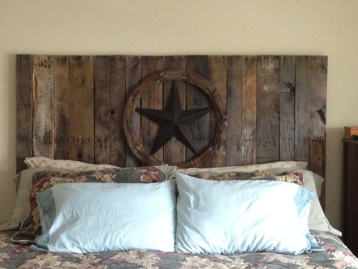 a bed that has some pillows on it and a wooden star above the headboard