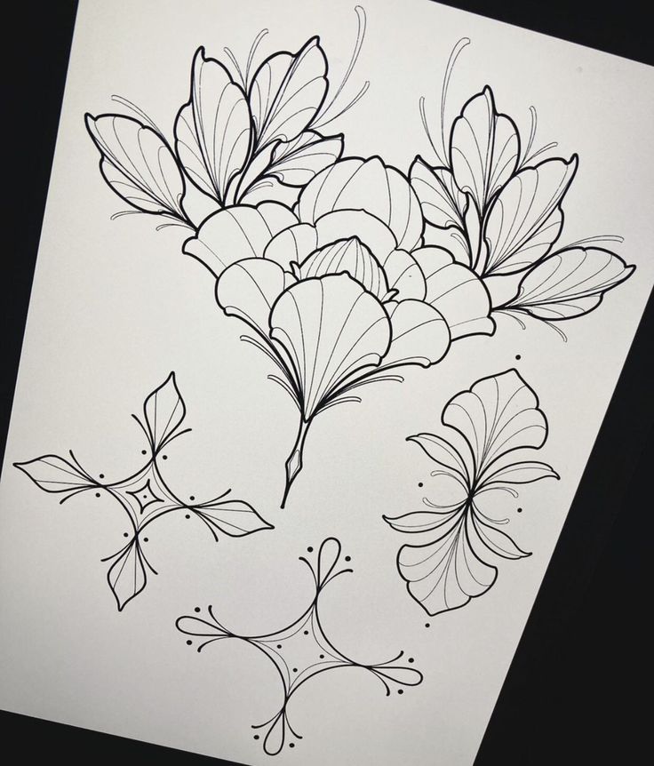 some flowers and leaves are drawn on paper