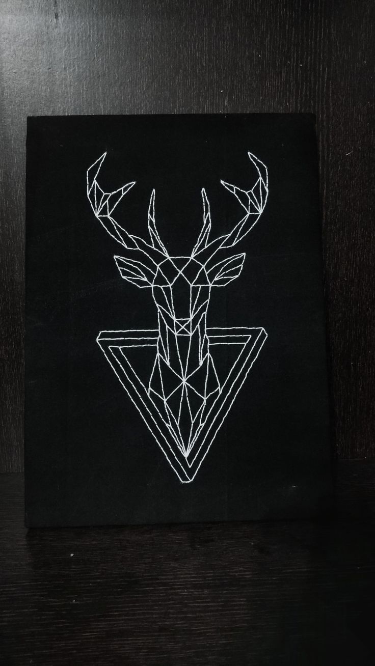 a black and white photo of a deer's head with geometric shapes on it