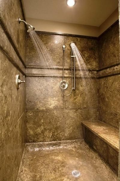 an image of a shower in a bathroom with lights on the ceiling and no curtain