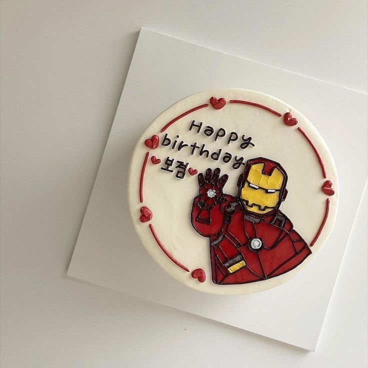 a birthday cake decorated with the image of iron man