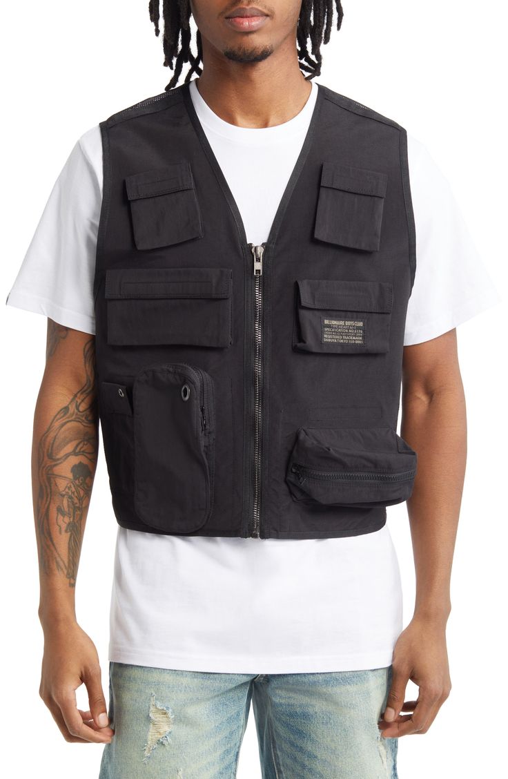 This front-zip utility vest is fitted with flap pockets and a breathable mesh back. 28" length (size Medium) V-neck 100% polyester Hand wash, line dry Imported Utility Nylon Vest Outerwear, Casual Nylon Vest For Outdoor Work, Sleeveless Black Outerwear For Outdoor Work, Black Outerwear With Patch Pockets For Outdoor Activities, Black Outerwear With Patch Pockets For Outdoor, Functional Vest With Cargo Pockets For Outdoor Work, Nylon Vest With Side Pockets For Outdoor Activities, Functional Nylon Vest For Outdoor Work, Black Nylon Vest For Outdoor Work