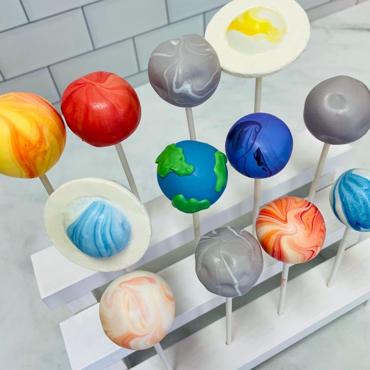 an assortment of colorful lollipops sitting on top of a white countertop