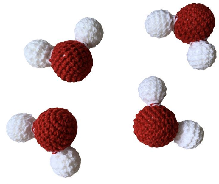 crocheted red and white balls are shown in three rows