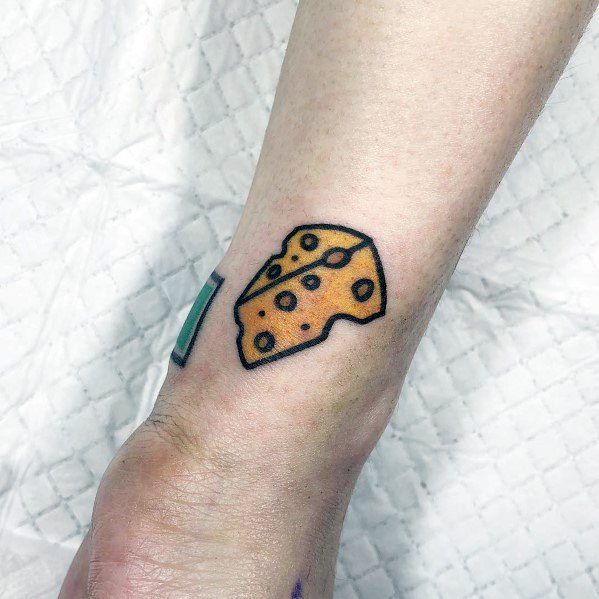 a piece of cheese tattoo on the left arm and wrist is shown in black ink