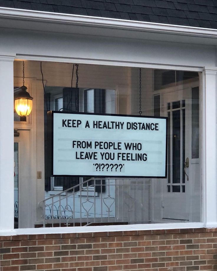 a sign that is on the side of a building saying keep a healthy distance from people who leave you feeling