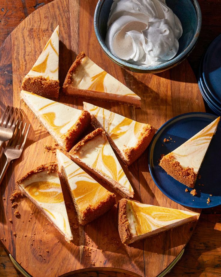 slices of cheesecake sitting on top of a wooden cutting board