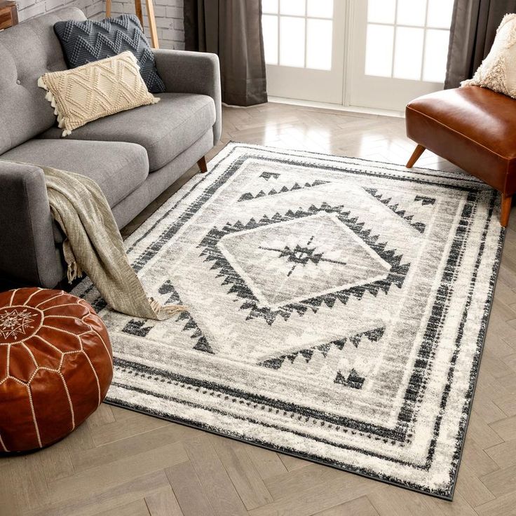 a living room with a couch, chair and rug