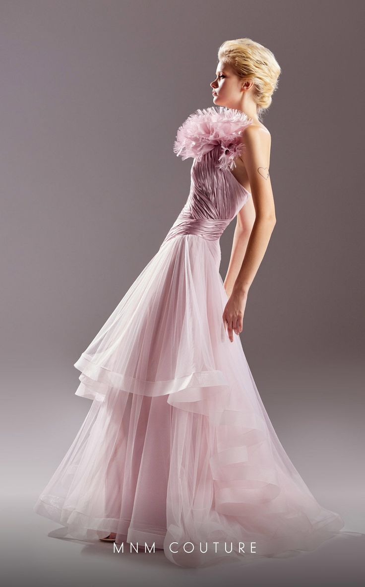 Make a statement at your next couture event, evening affair, or as the mother of the bride with the MNM Couture A-Line Evening Dress. This exquisite gown is crafted from a combination of tulle and organza, creating a stunning and ethereal look. The A-line style of the dress flatters all body types, gracefully skimming the waist and hips before cascading into a voluminous and flowing skirt. It offers a timeless and elegant silhouette that is both flattering and comfortable to wear. The pleating d Luxury Tulle Evening Dress For Formal Events, Elegant Evening Organza Ball Gown, Elegant Tulle Ball Gown With Sweep Train, Fitted Bodice Organza Evening Dress For Gala, Organza Evening Dress With Detachable Train For Gala, Elegant Tulle Mother Of The Bride Evening Dress, Glamorous Organza Ball Gown For Gala, Tulle Ball Gown For Gala Evenings, Luxury Evening Tulle Gown