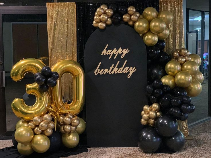 a black and gold 30th birthday decoration with balloons