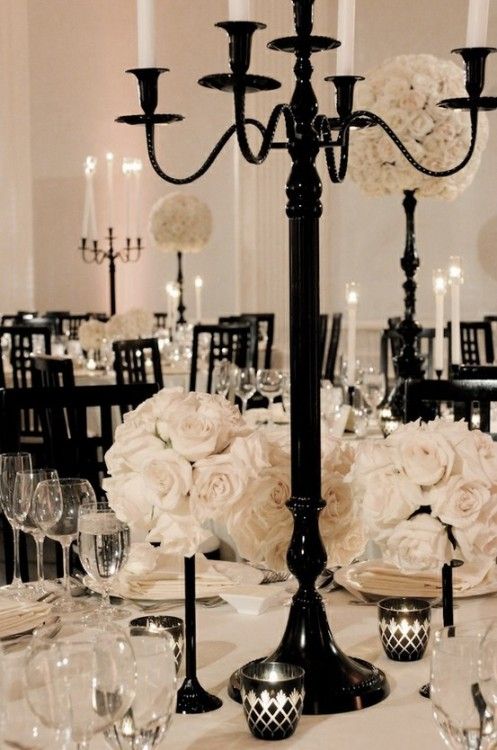 an elegant centerpiece with flowers and candles