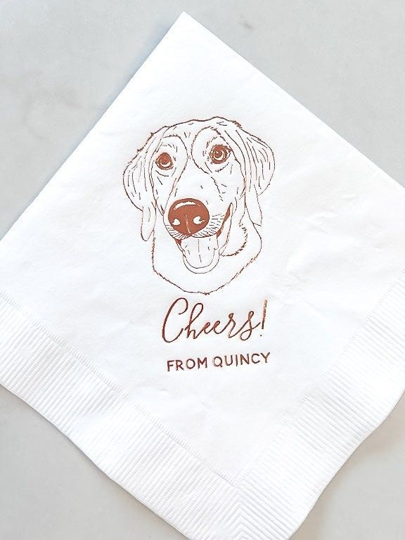 a white napkin with a brown dog's face on it and the words cheese from quincy