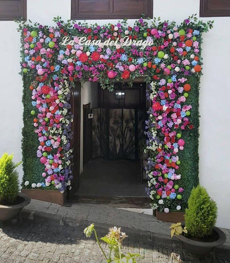 an entrance to a building decorated with flowers