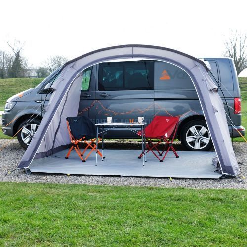 a van is parked in front of a tent