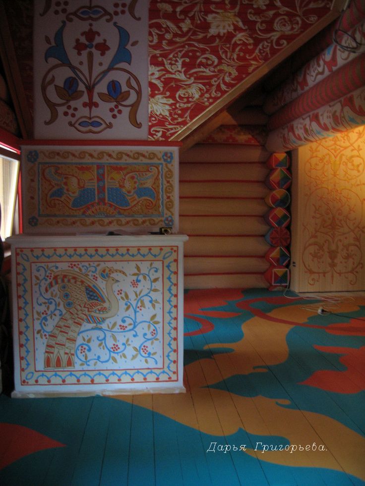 an artisticly designed room with colorful carpeting and decorative wallpaper on the walls