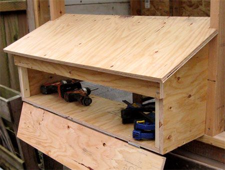 a wooden shelf with toy cars in it and some wood planks on the side