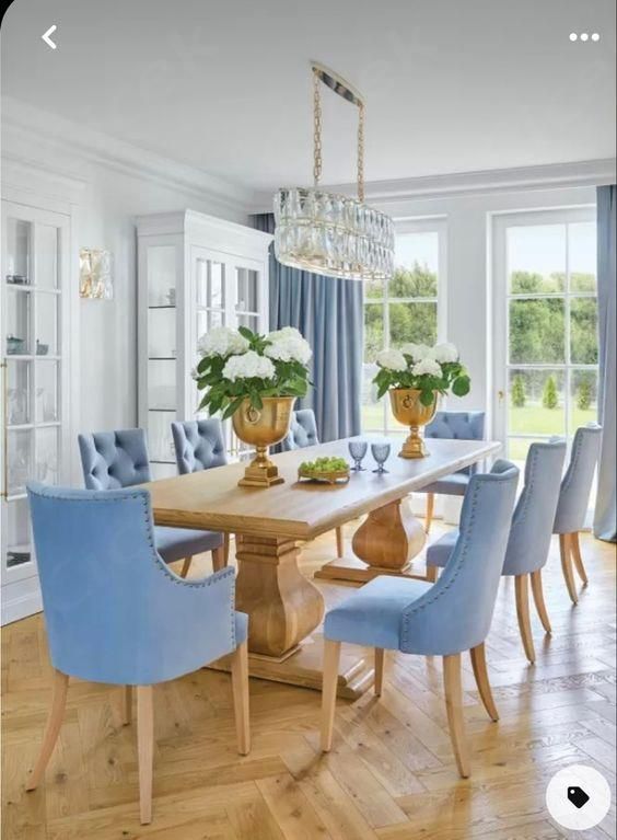 a dining room with blue chairs and a wooden table